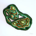 Decorative stone with green and brown patterns on a white background