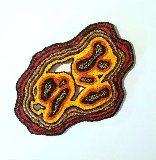 Agate-like decorative item with layered colors on a white background