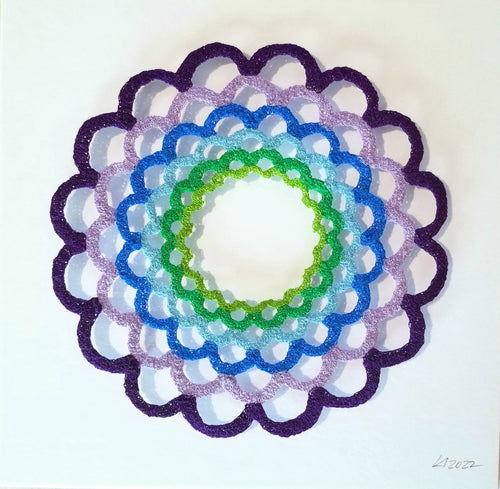 Decorative circular design with concentric rings in purple, blue, green, and white on a white background.