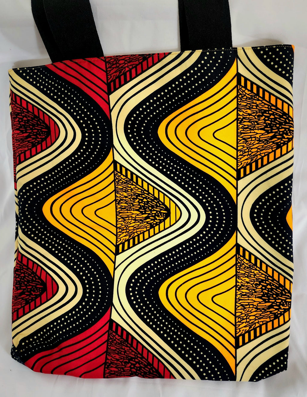 Tote bag with a vibrant, multicolored pattern on a white background