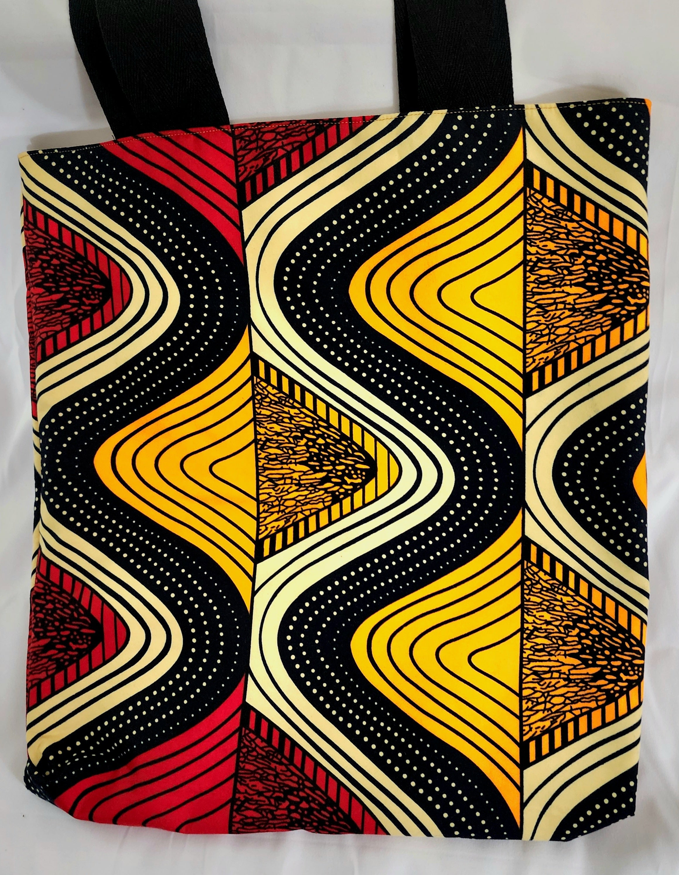 Tote bag with a vibrant, multicolored pattern on a white background