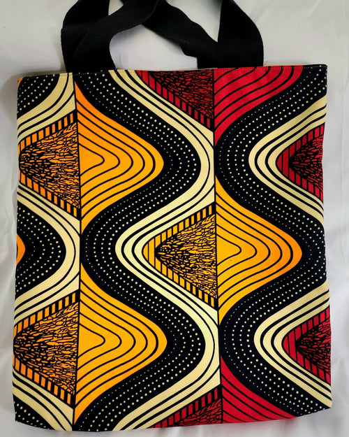 Tote bag with a geometric pattern featuring black, orange, and red colors on a white background.