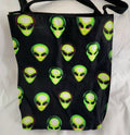 Black tote bag with green alien heads pattern on a white background