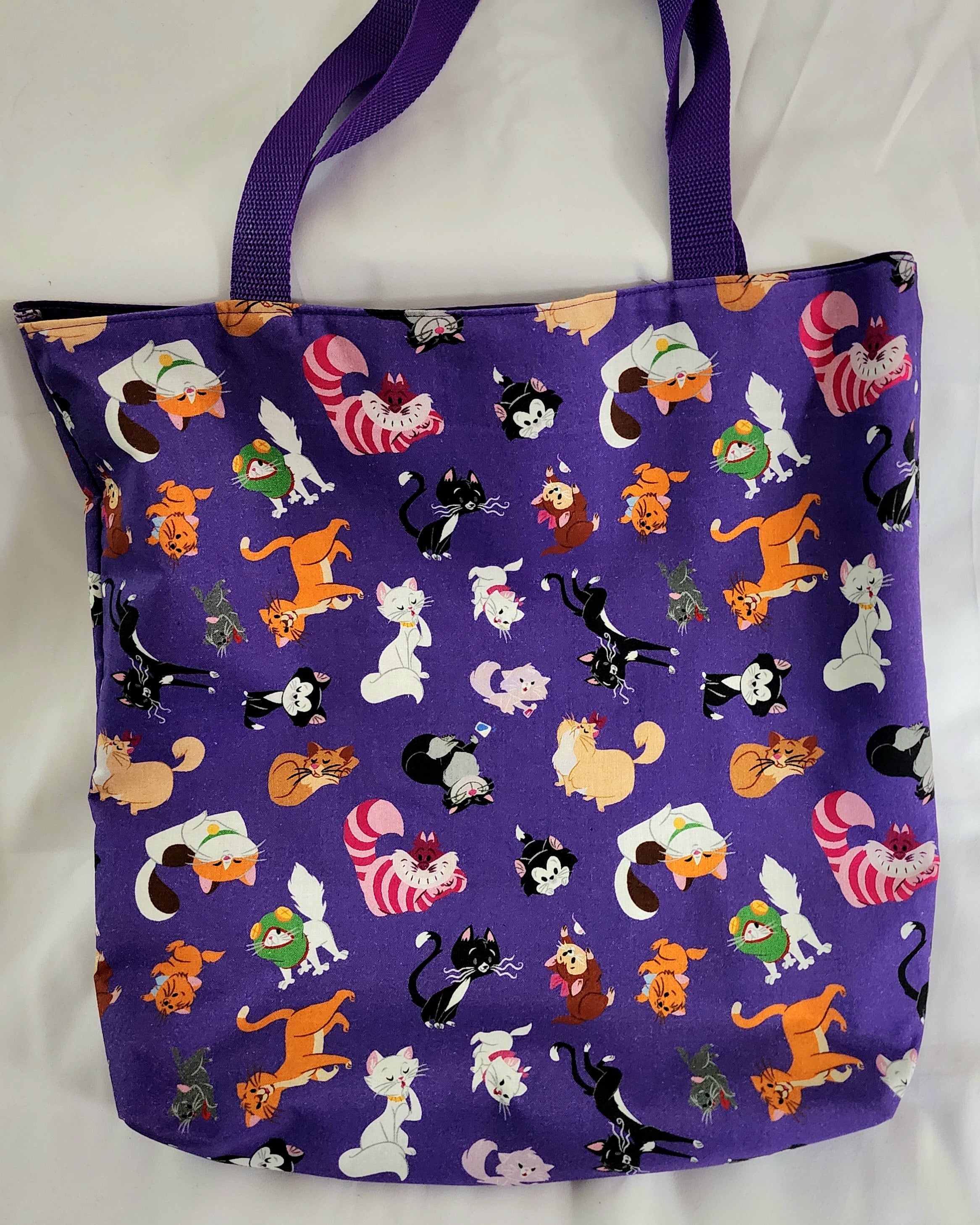 Tote bag with cartoon cat pattern on a purple background