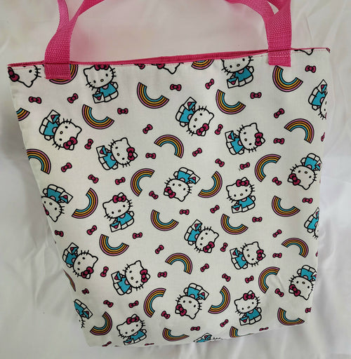 Tote bag with Hello Kitty pattern and pink handles on a white background