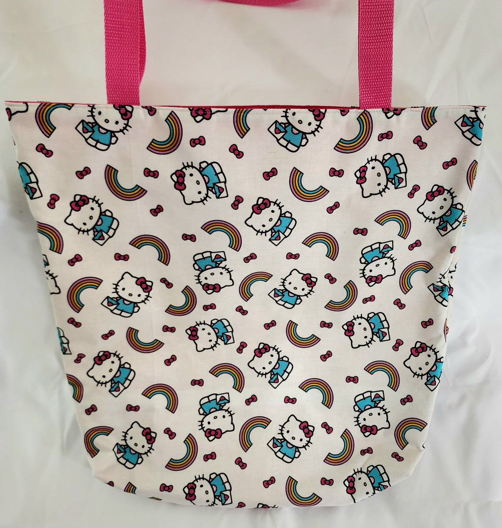 Tote bag with Hello Kitty pattern and pink handles on a white background