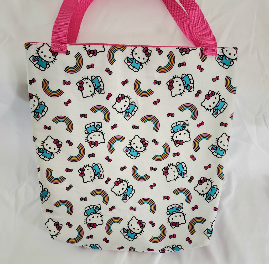 Tote bag with Hello Kitty pattern and pink handles on a white background