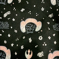 Tote closeup 'The Future of the Galaxy is Female" text on a black fabric background with star patterns