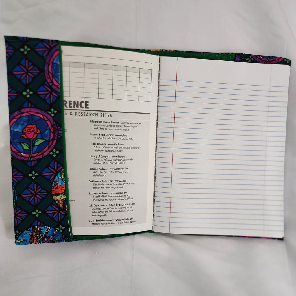 Open notebook with colorful fabric cover on a white background