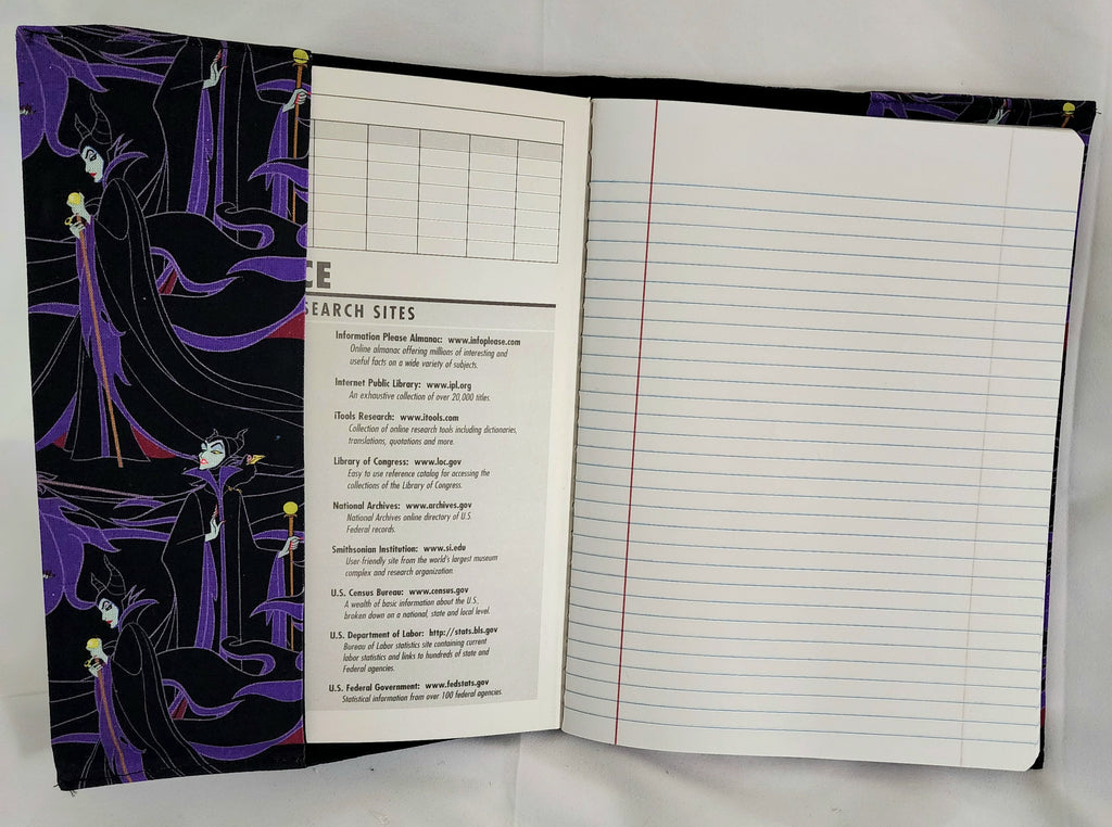 Open notebook with decorative cover and lined pages on a white background