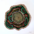 Geological sample with layered rock colors on a white background