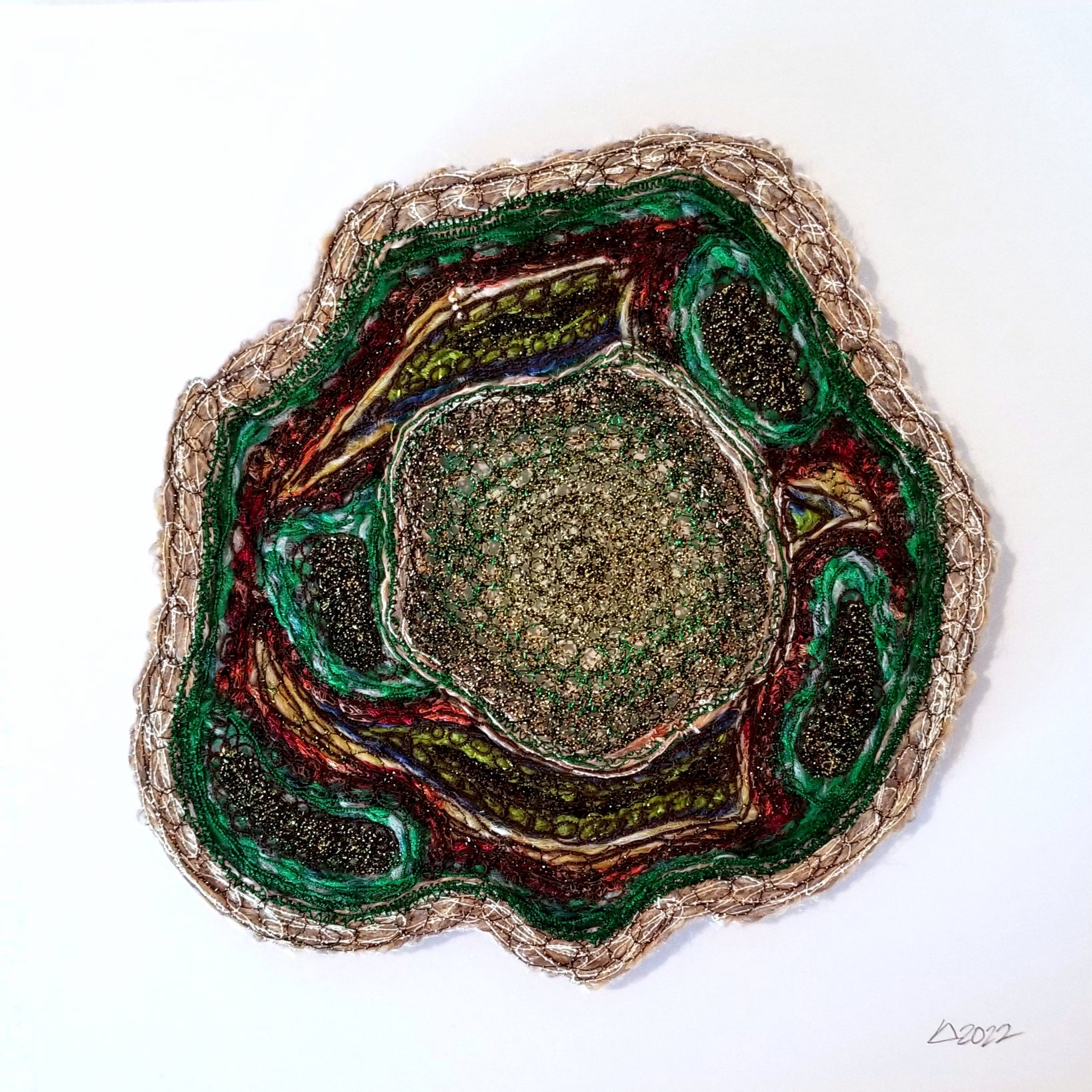 Geological sample with layered rock colors on a white background