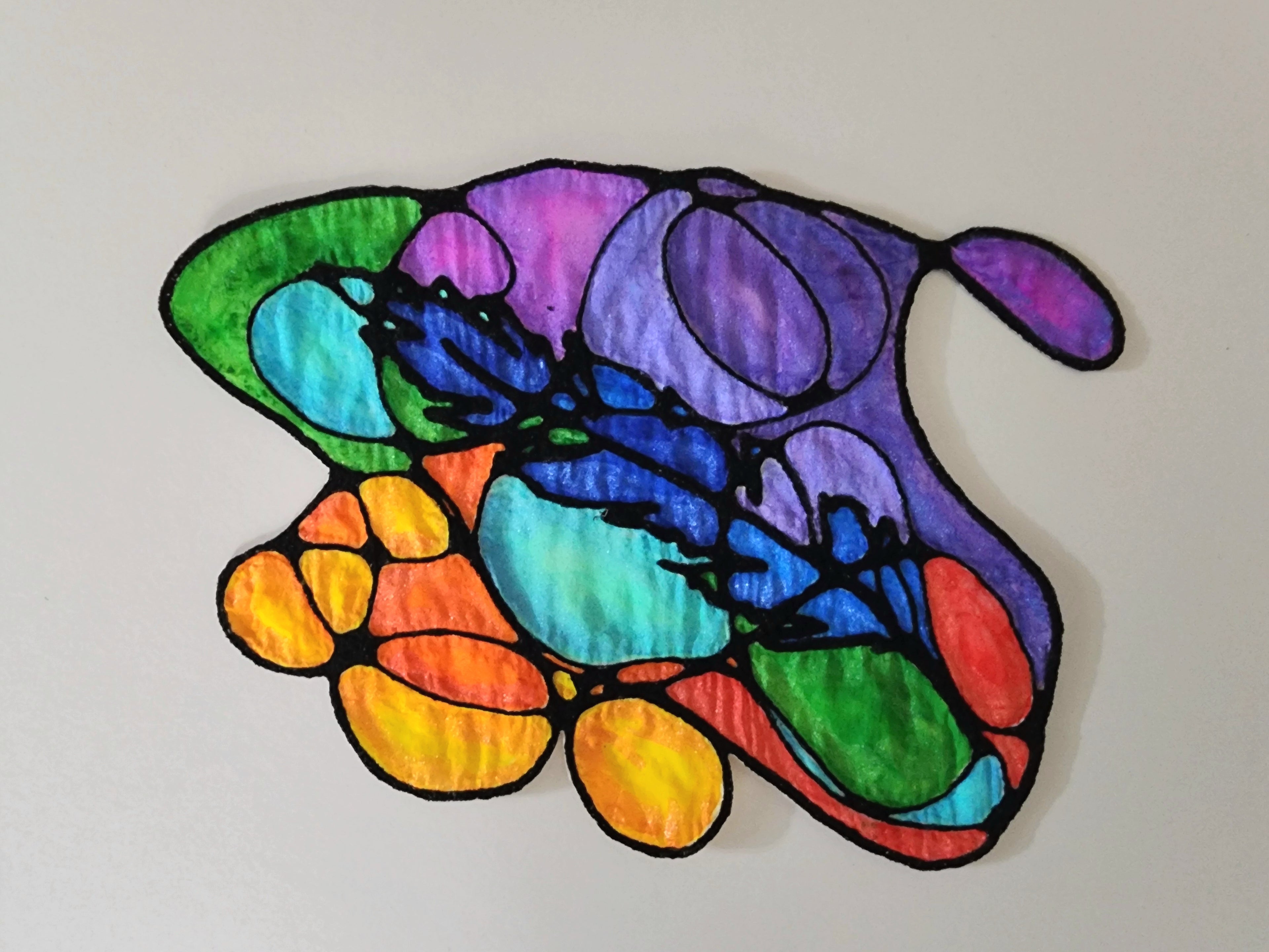 Colorful feather-shaped stained glass panel on a white background