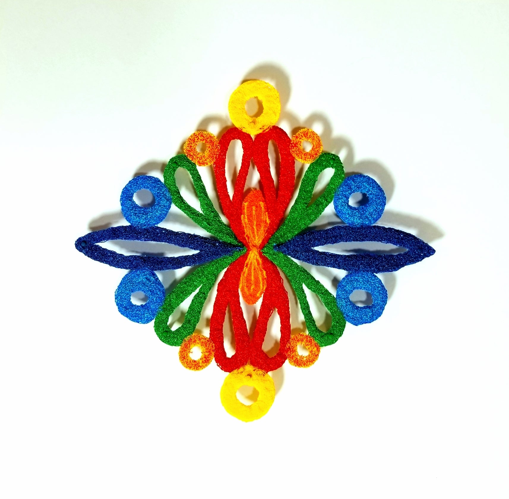 Colorful butterfly-shaped object made of interlocking rings on a white background