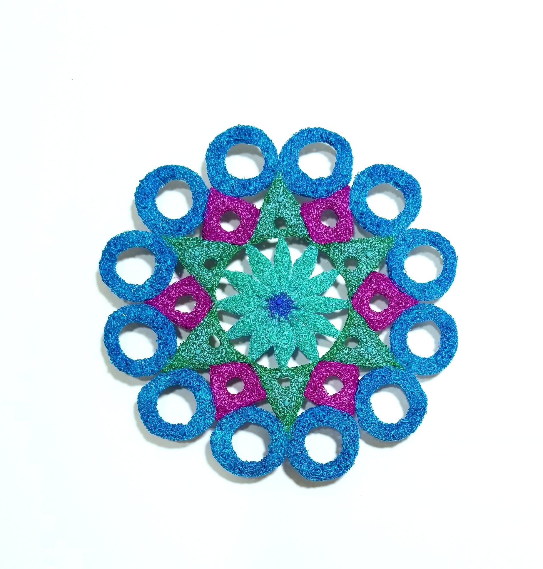 Mandala with blue circle ring, green, and pink circular patterns on a white background