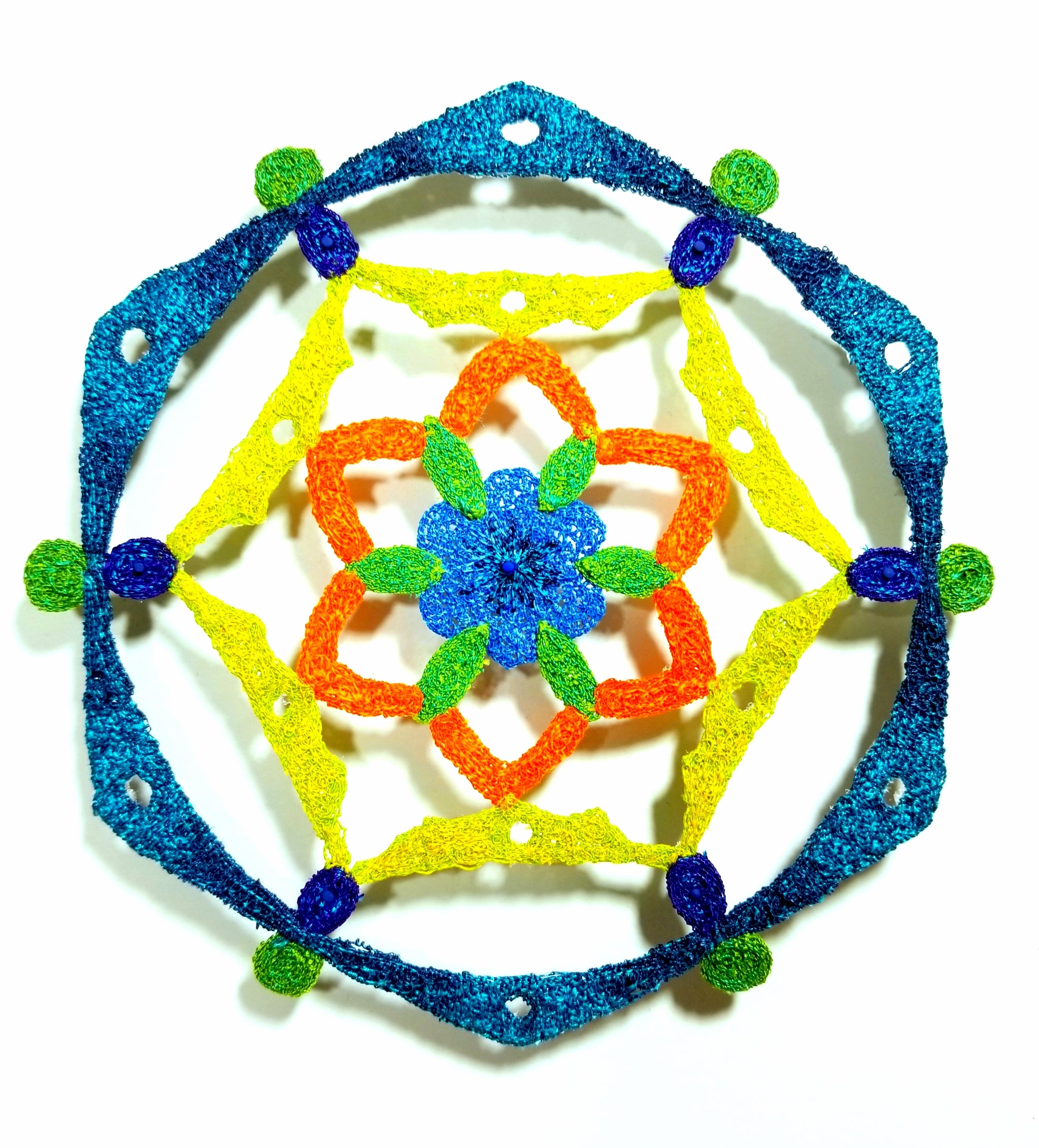 Mandala geometric pattern with blue, yellow, and orange colors on a white background