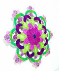 Mandala with purple and green flowers on a white background