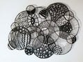 Black and white abstract circular patterns made entirely of thread on a white background