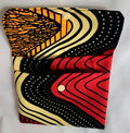 Colorful patterned clutch bag with gold buttons on a white background