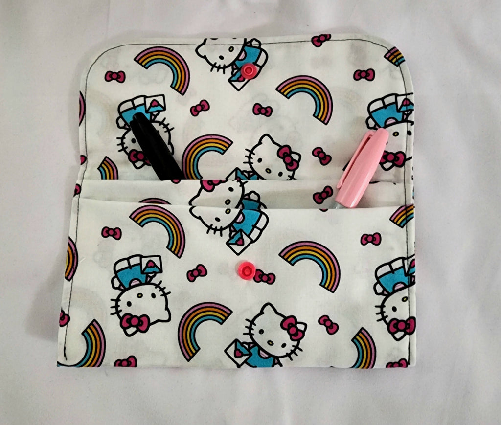 Hello Kitty pouch with rainbow patterns on a white background