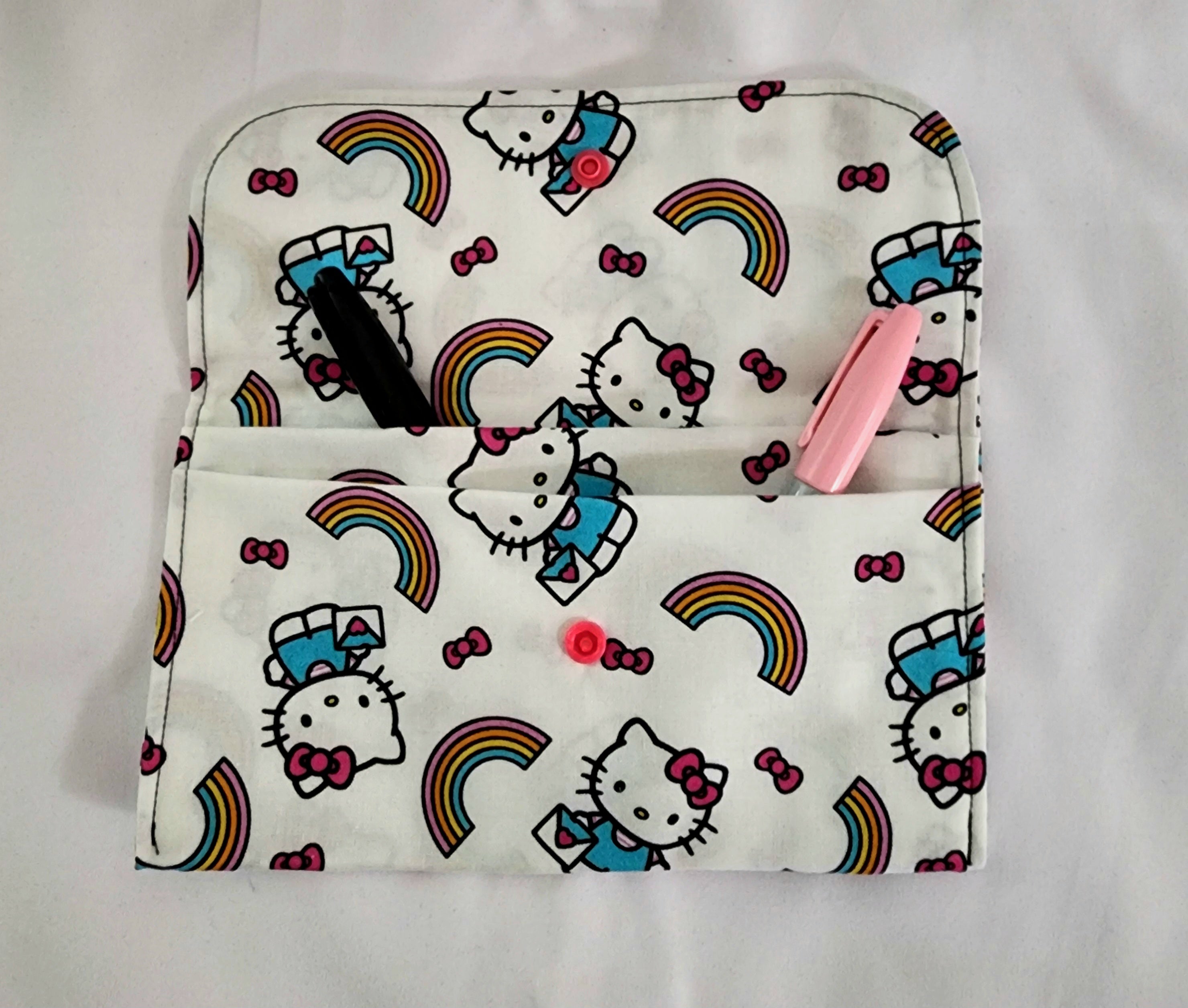 Hello Kitty pouch with rainbow patterns on a white background