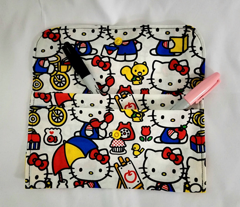 Hello Kitty-themed pouch with colorful designs on a white background