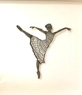 Decorative wall sculpture of a dancer in a flowing pose on a light background