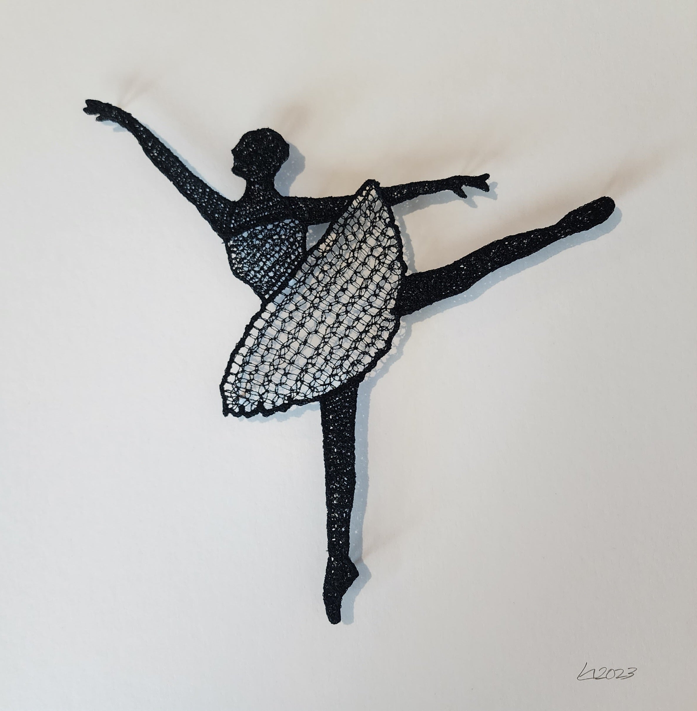 Silhouette of a dancer made from black thread on a white background