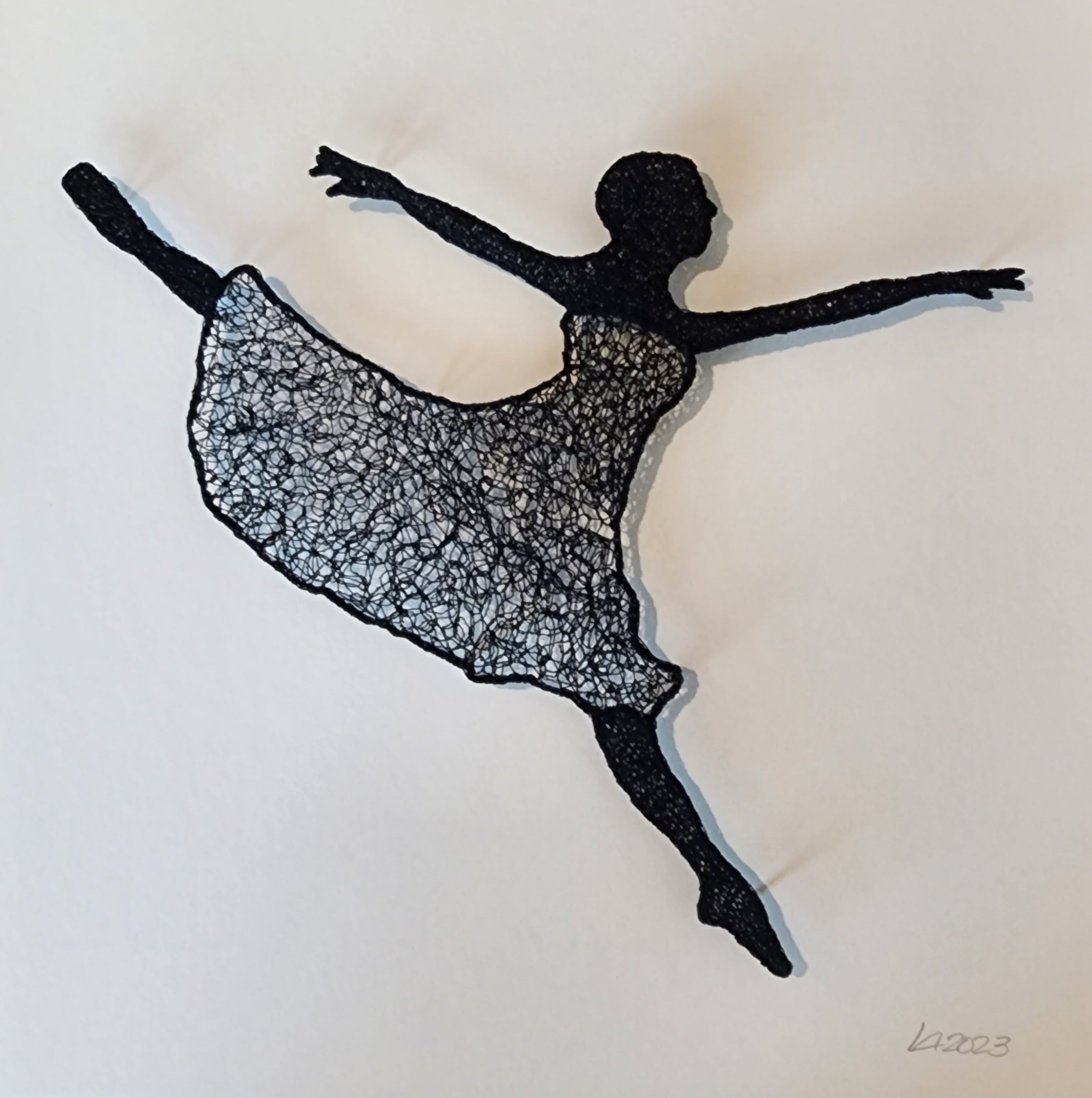 Silhouette of a dancer made from thread art on a white background